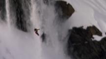 Snowboarder Drops A Cliff And Flails In The Air.