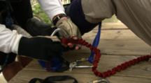 Close Up Of A Man Prepping Bungy Jumping Equipment.
