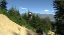 A Mountain Biker Straight Airs Two Big Jumps.