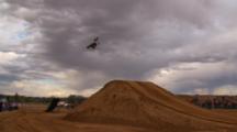 A Line Of Motocross Riders Hit A Big Jump One After The Other.