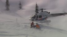 Helicopter Lands In The Snow And Picks Up Some Skiers.