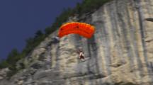 Man In A Wing Suit Base Jumps Off A Cliff.