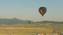 Hot Air Balloons Over A Valley.