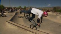 Bmx Rider Doing A Stall At A Skate Park.