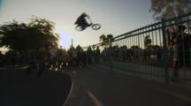 Bmx Rider Jumping A Fence.