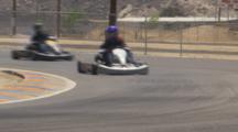 Go Karts Racing Around A Corner.