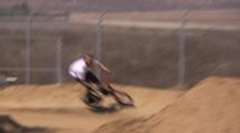 Bmx Riders In A Train Hitting Several Dirt Jumps.