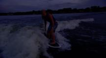 Tracking A Female Wakesurfer Riding Behind A Boat.