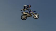 Tracking Three Motocross Riders Doing Tricks On A Jump.