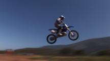 Tracking A Motocross Rider Riding A Dirt Track.