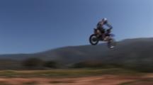 Tracking A Motocross Rider Riding A Dirt Track.