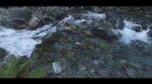 Rocky Creek Flowing Crystal Clear To Foaming Cascade. Cine-Slider Shot