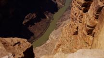 Grand Canyon Rim, Showing The Colorado River One Mile Below With Tiny Boat Going Down River. Arizona.