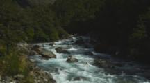 Rushing River Flowing Over Rocky Bottom, White Water And Glacial Influence.