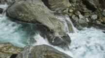 Haast Pass, Tight Shot Of River Rushing Over Rocky Canyon, Aqua Blue Fresh Water.