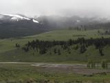 River Valley With Green Grass, And Snowy, Misty Mountains