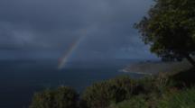 Time Lapse Of Clouds And Rainbow Moving Along Coast