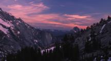 A Brilliant Pink Sky Glows At Sunset At Olmstead Point In Yosemite National Park, California. Clouds Rest Still Has Snow Cover, Half Dome Is Visible On The Right.