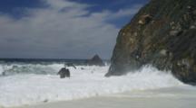 Waves Crash Onto The Cliffs And Beach Of Big Sur
