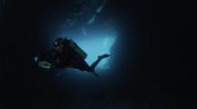  A Female Underwater Photographer Explores A Large Cavern