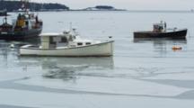 A Vessel Departs A Fishing Harbor As Ice Breaks