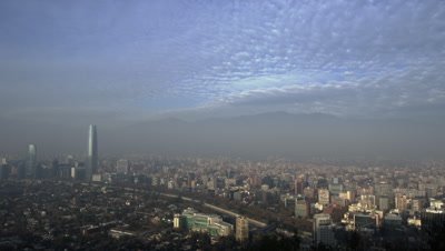 The City skyline of Santiago, Chile lies between mountains and extensively traps smog