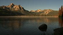Mountains Reflected In Lake With Tule Fog And Ducks Swimming