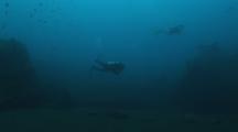 Scuba Divers Explore The Usat Liberty Shipwreck At Tulamben, Bali