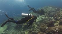 Divers Swimming Into Strong Current Over Coral Reef