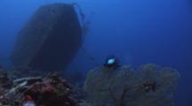 Bow Of The Nasi Yalodina Shipwreck With Scuba Divers