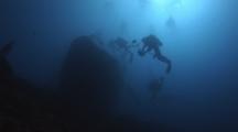 Underwater Photographer And Scuba Divers Explore The Nasi Yalodina Shipwreck