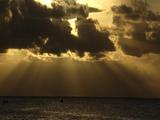 Heavenly Rays Of Sun Beam Through Clouds Onto Sea & Two Tiny Boats