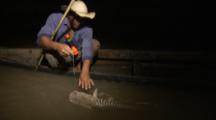 Man Fishing In Canoe At Night, Reels In Large Cat Fish