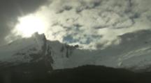 Time Lapse Clouds Move Over Snow-Covered Jagged Mountains