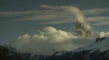 Time Lapse Clouds Move Over Snow-Covered Jagged Mountains, Possibly Mount Fitz Roy