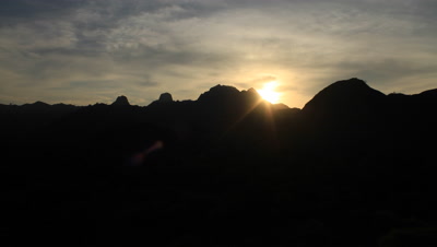 Time Lapse of sun rising over mountains and cloudy skies at Komodo National Park