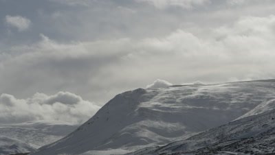 General view of snow covered mountains and cloudy skies