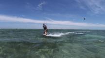 Lock Shot Of Female Kiteboarder Jumping In Front Of Camera