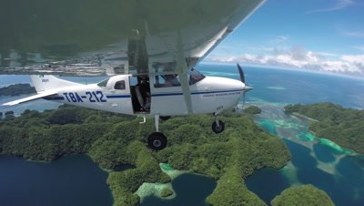 Action cam mounted to wing of light aircraft as it flies over Palau's UNESCO World heritage site