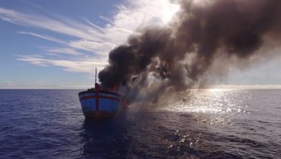 drone aerial shot of illegal fishing boat burning