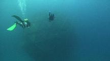 Wide Shot Of Two Divers Approaching An Aquapod Fish Farm