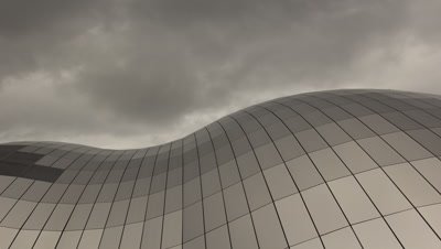 Mid shot of the arch in the Sage roof with clouds moving over the building at a fast pace.