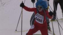 American Birkebeiner, Skiers Climbing Hill On Trail Through Woods, Colorful Hats, Suits