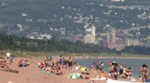 People Sunning, Enjoying The Beach, Water, On Lake Superior, Duluth In Bg