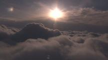 Aerial Flying Through Cloud Tops Looking Into Setting Sun
